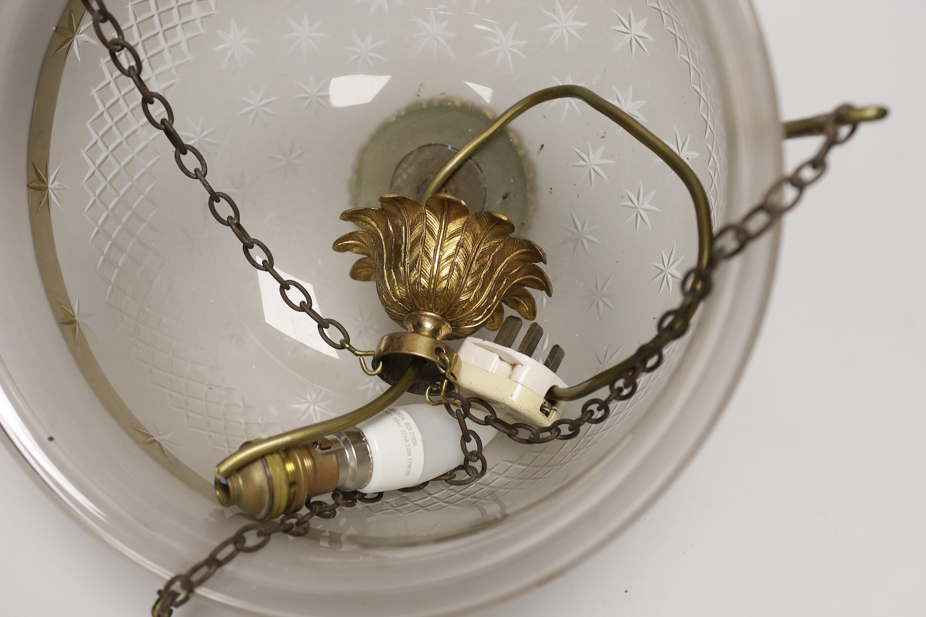 A gilt brass and frosted glass ceiling dome, the brass mounts cast with flowers, 36cm in diameter